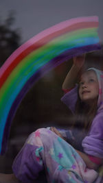 Rear view of smiling girl with multi colored hair