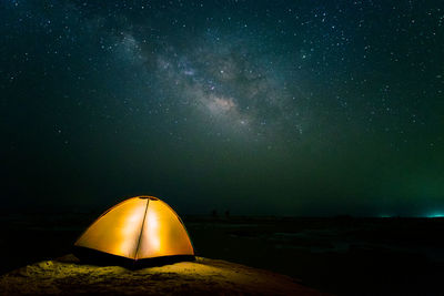 Illuminated tent against sky at night