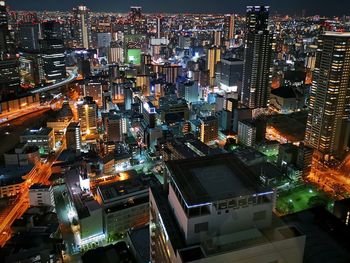 High angle view of illuminated city buildings at night