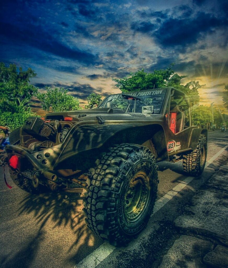 sky, transportation, mode of transport, cloud - sky, land vehicle, car, cloudy, tree, cloud, field, outdoors, no people, wheel, nature, stationary, day, travel, tire, landscape, abandoned