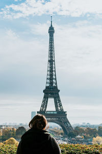Rear view of woman standing by eiffel tower