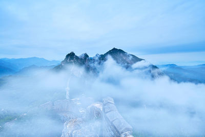 View of mountain range against cloudy sky