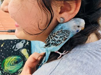 Midsection of woman holding bird