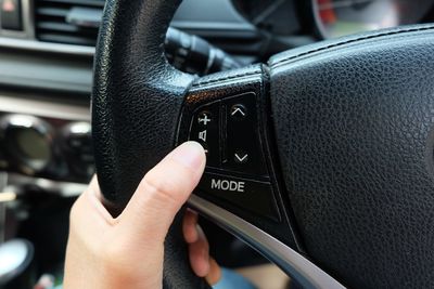 Close-up of hand holding black car