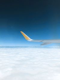 Airplane flying over cloudscape against sky