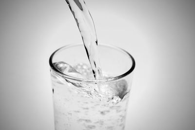 Close-up of drink in glass against white background