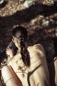 Naked strong back with dappled light in nature