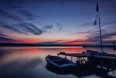 Boat in sea at sunset