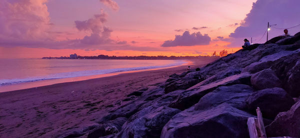 Scenic view of beach against sky during sunset