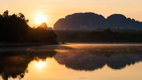Beautiful lake with motion mist and limestone mountains, nong thale, krabi, thailand.