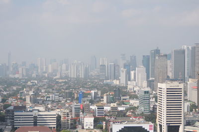 High angle view of buildings in city against sky