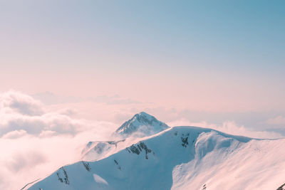 Scenic view of snowcapped mountains against sky during sunset