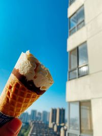 Close-up of hand holding ice cream cone