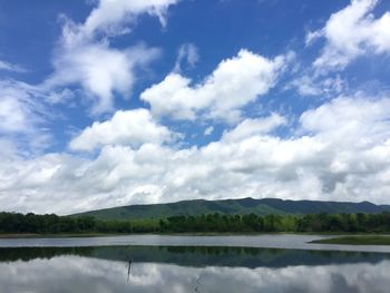 Scenic view of lake and mountains against sky