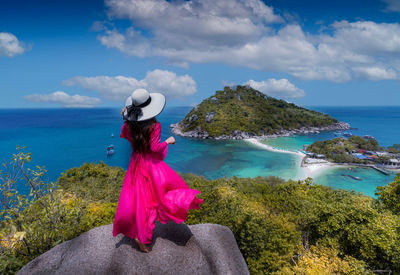 Woman looking at sea against sky