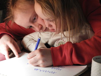 Close-up of brother teaching sister