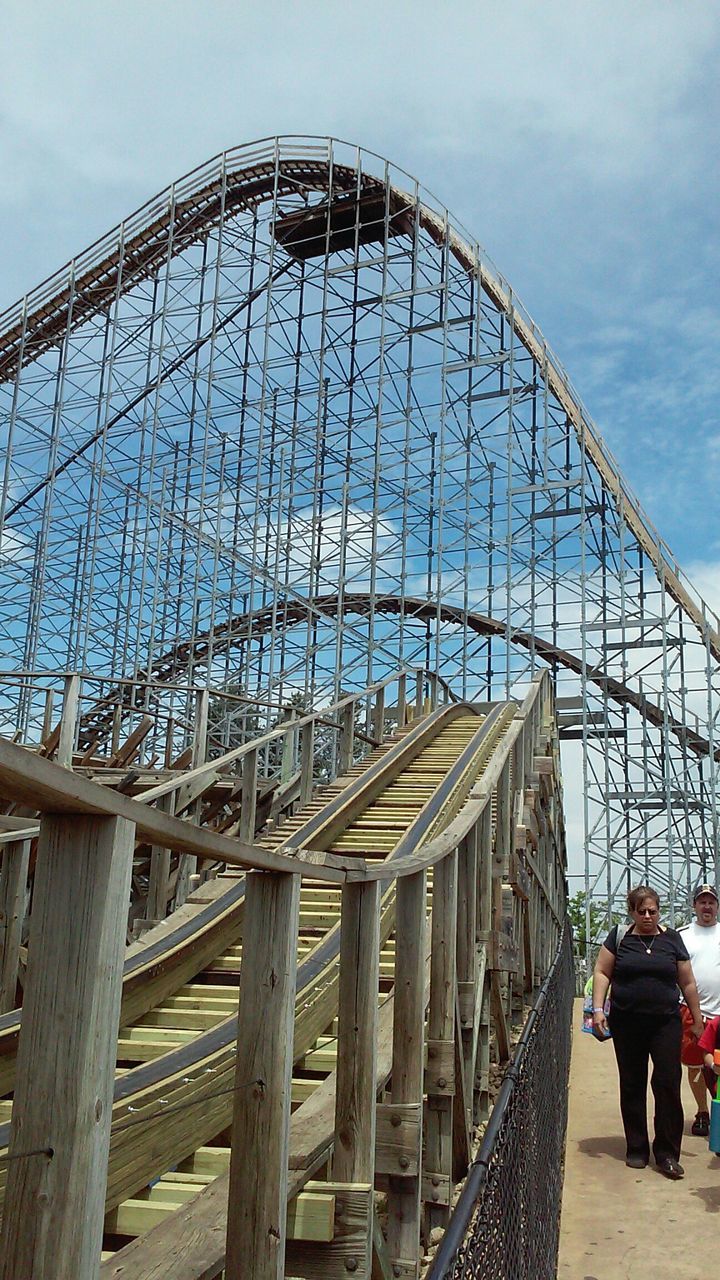 built structure, architecture, sky, men, leisure activity, low angle view, lifestyles, person, building exterior, amusement park ride, famous place, bridge - man made structure, travel destinations, amusement park, travel, tourism, metal, cloud - sky, walking