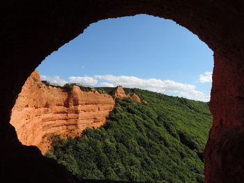 View of rock formations through arch