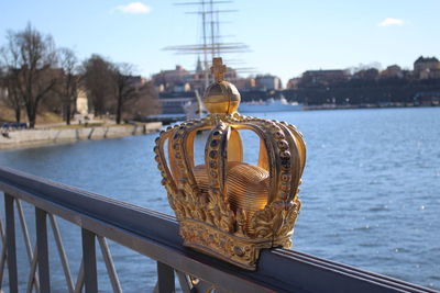 Royal swedish crown on skeppsholmen bridge on sunny day