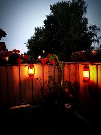 Illuminated lantern by building at night