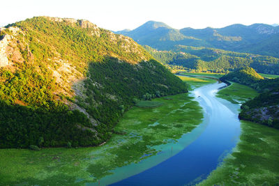 High angle view of river amidst mountains against sky