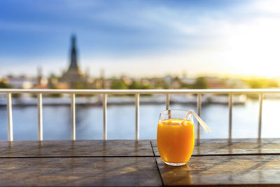 Close-up of drink on table against sky