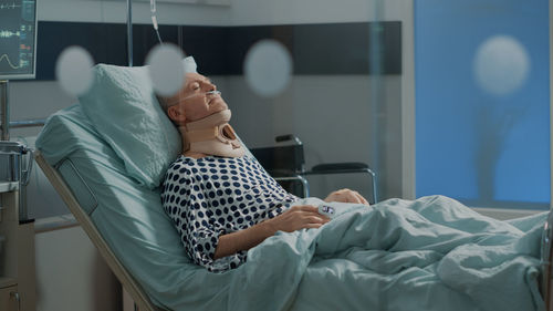 Man resting on hospital bed