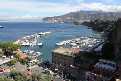 High angle view of city by sea against sky