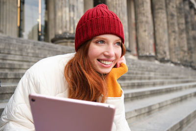 Portrait of woman using digital tablet