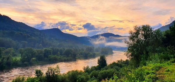 Scenic view of river against sky during sunset