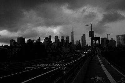 View of city road against cloudy sky