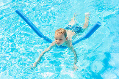 High angle view of boy swimming in pool