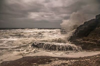 Scenic view of sea against cloudy sky