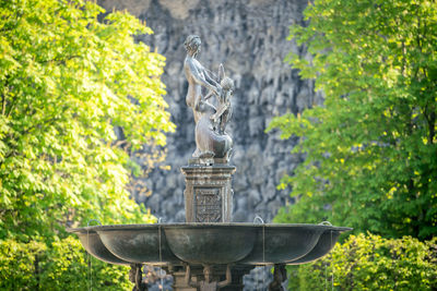Historic fountain with statues surrounded by trees, detailed shot, prague, czechia