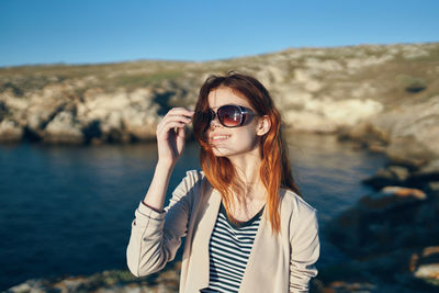 Portrait of young woman standing outdoors