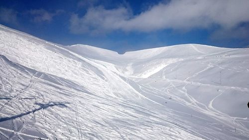 Scenic view of snow covered mountains against sky