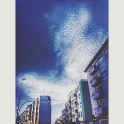 Low angle view of buildings against clear blue sky