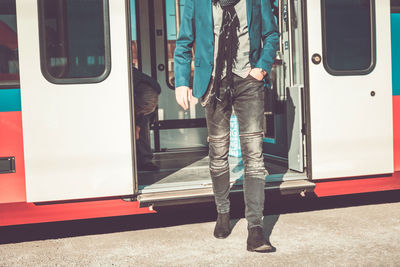 Low section of man walking at railroad station platform