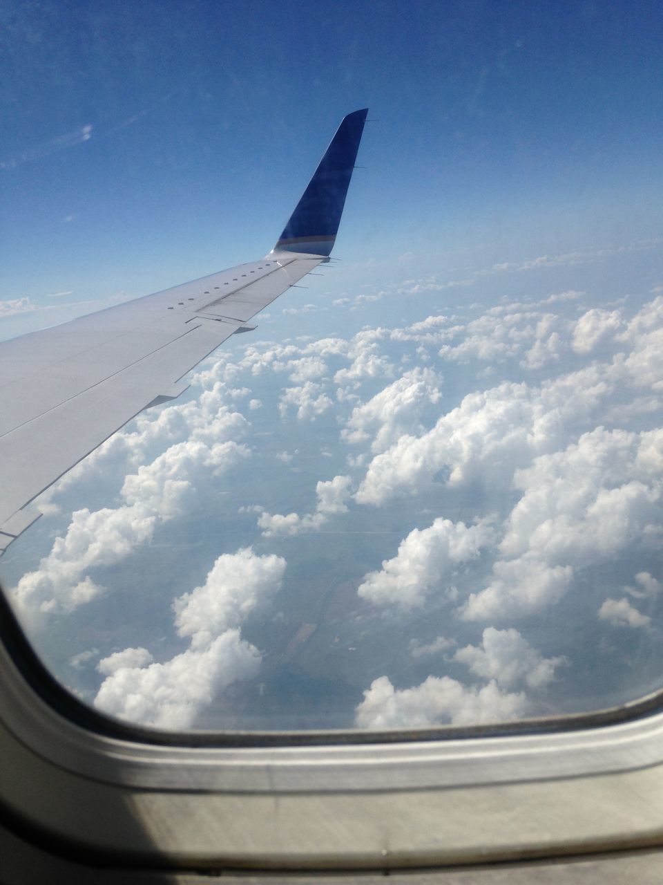 airplane, transportation, air vehicle, mode of transport, aircraft wing, part of, sky, cropped, cloud - sky, flying, travel, aerial view, window, cloud, journey, on the move, vehicle interior, vehicle part, scenics, day