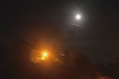 Low angle view of illuminated dark dark sky