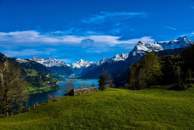 Scenic view of mountains against blue sky