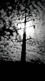 Low angle view of electricity pylon against sky