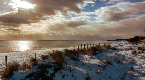 Scenic view of lake against sky during winter