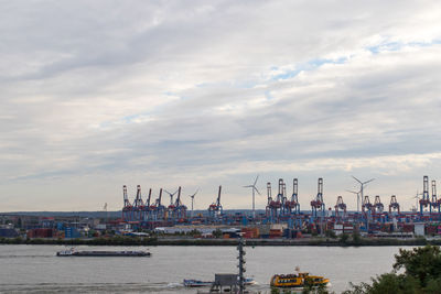 Commercial dock by sea against sky