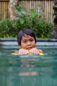 High angle view of cute kid swimming in pool