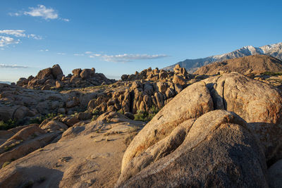 Rock formations on landscape against sky