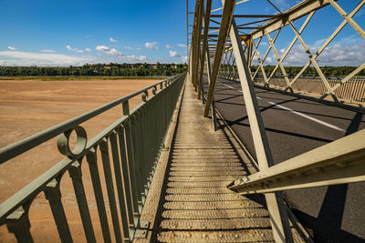 Loire valley metal bridge with diminishing perspective against blue sky