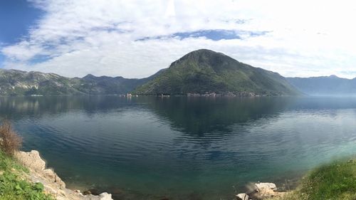 Scenic view of lake and mountains against sky