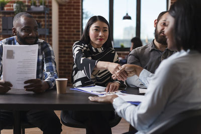 Businesswomen shaking hands in office