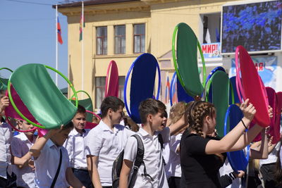 Group of people at multi colored umbrellas